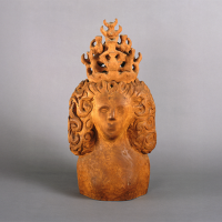 A sculpted bust of a woman with intricate curly hair and a large, ornate crown, set against a plain gray background.