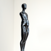 Silver metallic sculpture on a base with a white background