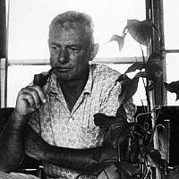    Forrest Bess with his painting Untitled (11A), in his home/studio, Chinquapin Bayou, near East Matagorda Bay, Texas, 1958. The Menil A...