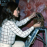 Woman kneeling before a painting