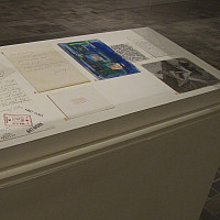 Display cases filled with artworks and letters for Roy R. Neuberger's 50th and 75th Birthday Books.