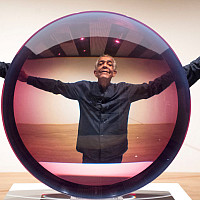 Artist Fred Eversley with 'Untitled (Parabolic Lens) 1971', made of cast polyster resin, during a press preview for the exhibition: Space...