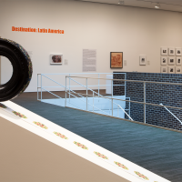 Exhibition photograph on the Museum's second floor gallery with various paintings, photographs, and sculptures on view