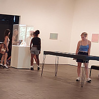 Photo of students viewing an exhibition in the Neuberger Museum of Art