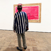 Romuald Hazoumè in the gallery of his retrospective exhibition, The Fâ Series