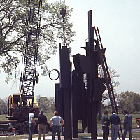 This installation shot shows the artist's 1976 black painted cor-ten steel sculpture Celebration II being craned into place for the exhibiti
