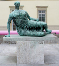 Moore's bronze Draped Reclining Woman (Die Liegende), 1957-1958, located in Stuttgart, Germany, is typical of his early reclining fi...