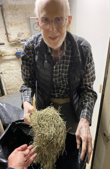 Luis Perelman in his studio with samples of shredded currency donated from the US Treasury Depart...