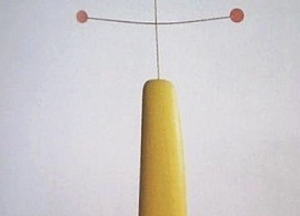 A modern sculpture featuring a tall yellow cone base with thin metal rods branching out at the top, each tipped with a red dot. The text GRA