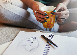 High angle shot of a young female student studying and working on an art sketch