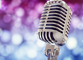 Retro singing microphone with stage lighting background