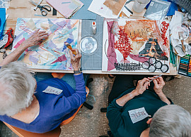 Overhead image of workshop participants making colorful collages