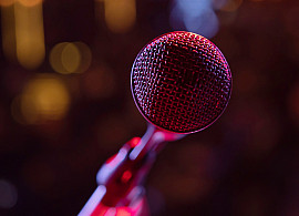 A microphone on stage concert with colorful lighting