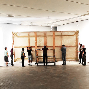Museum staff moving one of the 28 Threnody panels into the gallery