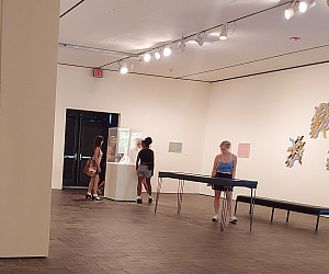 Photo of students viewing an exhibition in the Neuberger Museum of Art