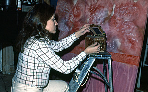 Woman kneeling before a painting