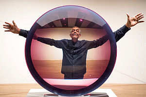 Artist Fred Eversley with 'Untitled (Parabolic Lens) 1971', made of cast polyster resin, during a press preview for the exhibition: Space...