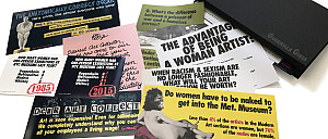 Several colorful postcards with bold text address gender inequality in art, including statistics and provocative questions.