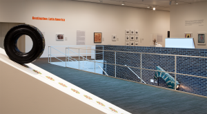 Exhibition photograph on the Museum's second floor gallery with various paintings, photographs, and sculptures on view