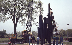 This installation shot shows the artist's 1976 black painted cor-ten steel sculpture Celebration II being craned into place for the exhibiti