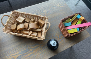 Wooden blocks. Magnetic blocks that are faded pink, blue, green and orange. Magic 8 ball.