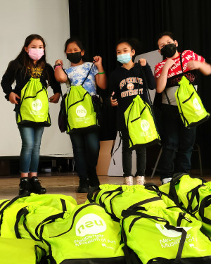 Children at the Enrico Fermi School in Yonkers receive NEU Kids Pack backpacks filled with art supplies from the Neuberger Museum of Art