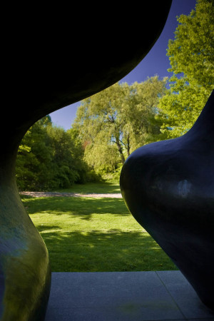 A view of the Purchase College campus through the curves of the Large Two Forms statue by Henry Moore