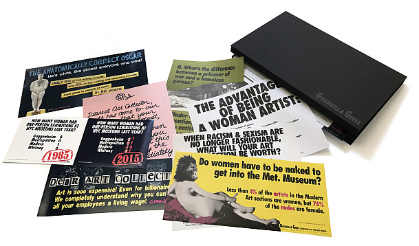 A set of colorful postcards with feminist and art-related messages, including statistics about women artists, are spread out on a white surf