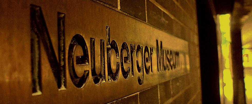 A picture of the front entrance signage with Neuberger Museum in view
