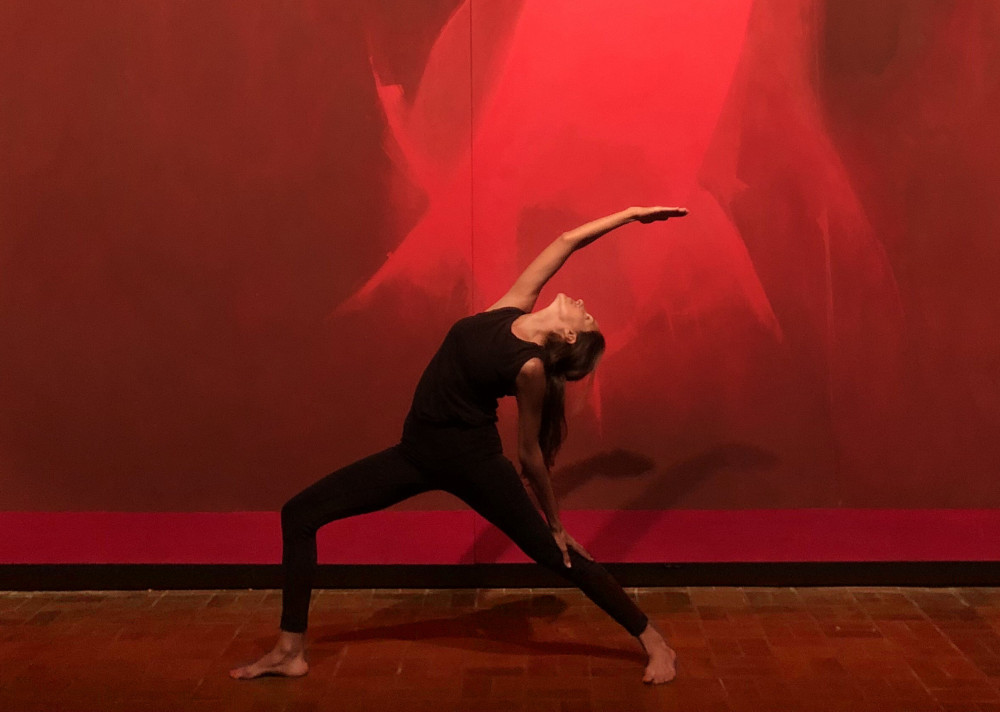 Jessica Pozzuoli performs yoga pose in Neuberger Museum of Art Theatre Gallery with Threnody by Cleve Gray