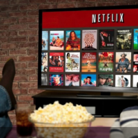 Three people on a couch decide what to watch on Netflix.