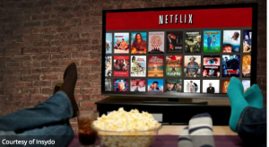 Three people on a couch decide what to watch on Netflix.