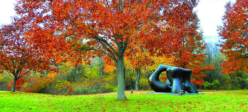 Large Two Forms statue by Henry Moore during autumn