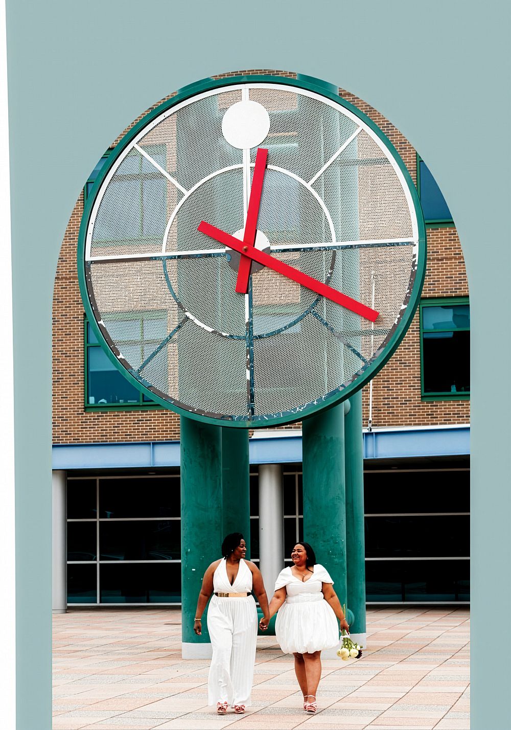 Jeidar Cole '15 and Jas'meena Melendez '15 hold hands near the big clock on campus