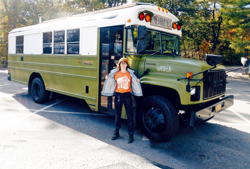 Holly Williams '15 stands in front of her tiny home and studio