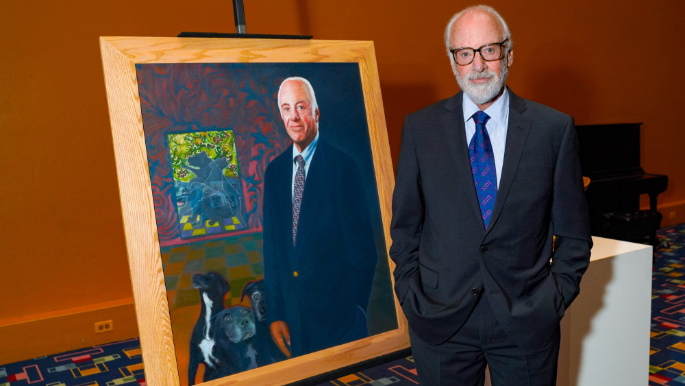 President Schwarz posing with his presidential portrait painted by Professor Emeritus Murray Zimiles during the celebration of his tenure...