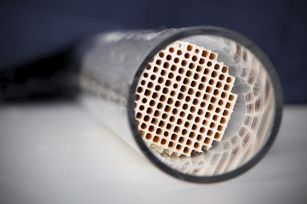 Interior view of a catalytic converter inside an exhaust pipe, where catalysts do their work.