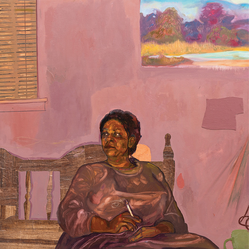 Woman sits on a bench in a room with window in front of a pink wall