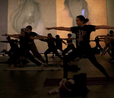 Class practices yoga in front of Threnody