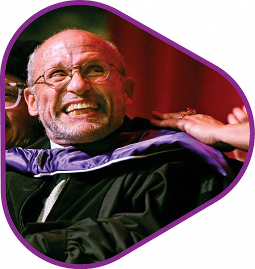 Adam Nagourney '77 in academic regalia in triangular photo frame with pink outline