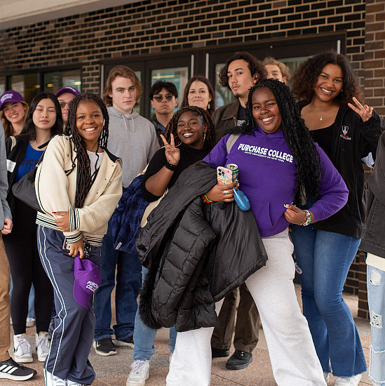 Group of students led by students in purple Purchase College sweatshirt