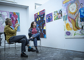 Facuty member conducts a painting critique