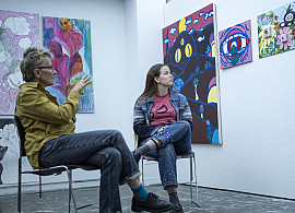 Facuty member conducts a painting critique