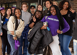 Group of students led by students in purple Purchase College sweatshirt