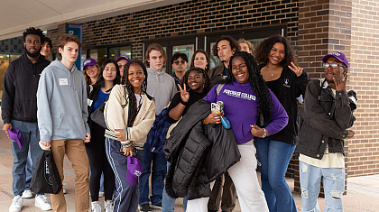 Group of students led by students in purple Purchase College sweatshirt