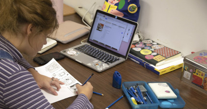 Student draws at desk