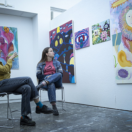 Facuty member conducts a painting critique