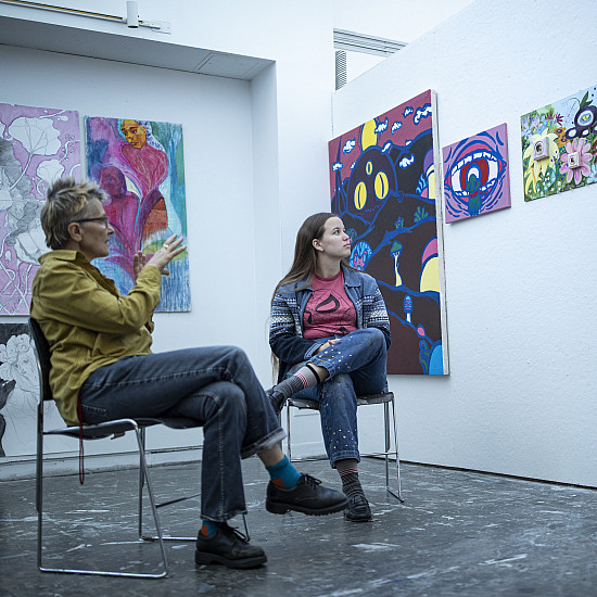 Facuty member conducts a painting critique