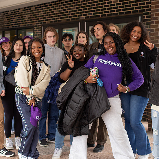 Group of students led by students in purple Purchase College sweatshirt