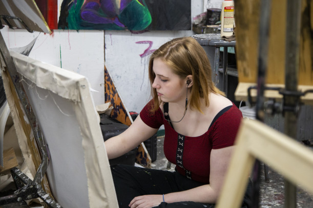 Paige Aaronson paints in her studio
